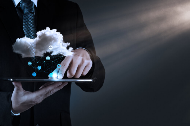 a businessman holding a tablet with a cloud and network icons symbolizing cloud computing technology