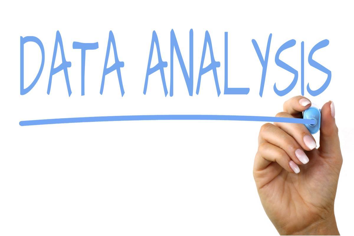 the text data analysis written in light blue with a hand holding a blue marker, underlining the words