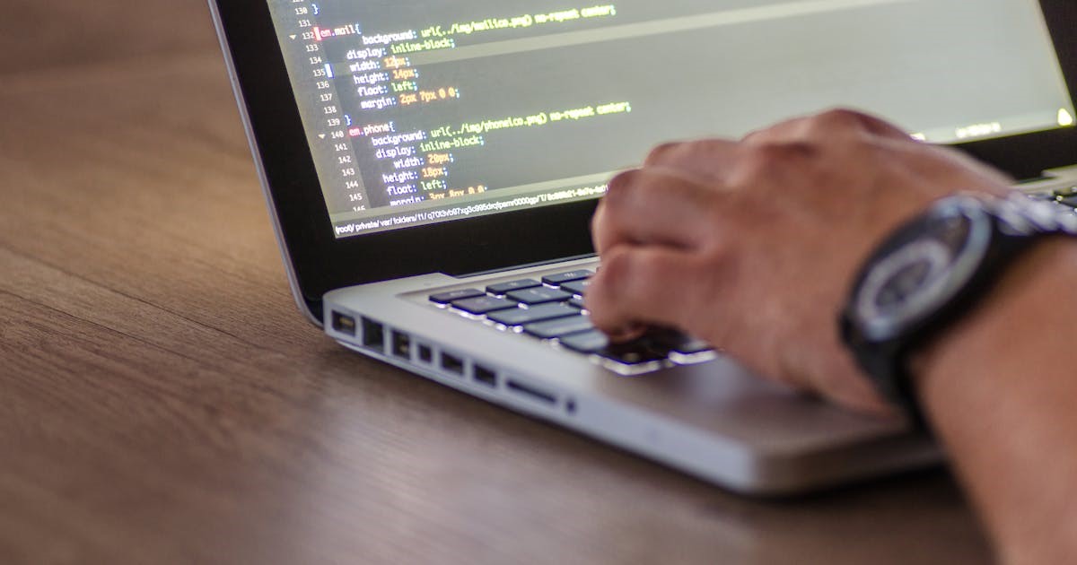 a person programming on a laptop