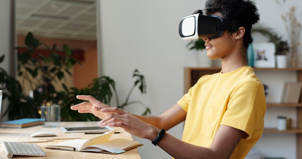 person using a VR headset at a desk