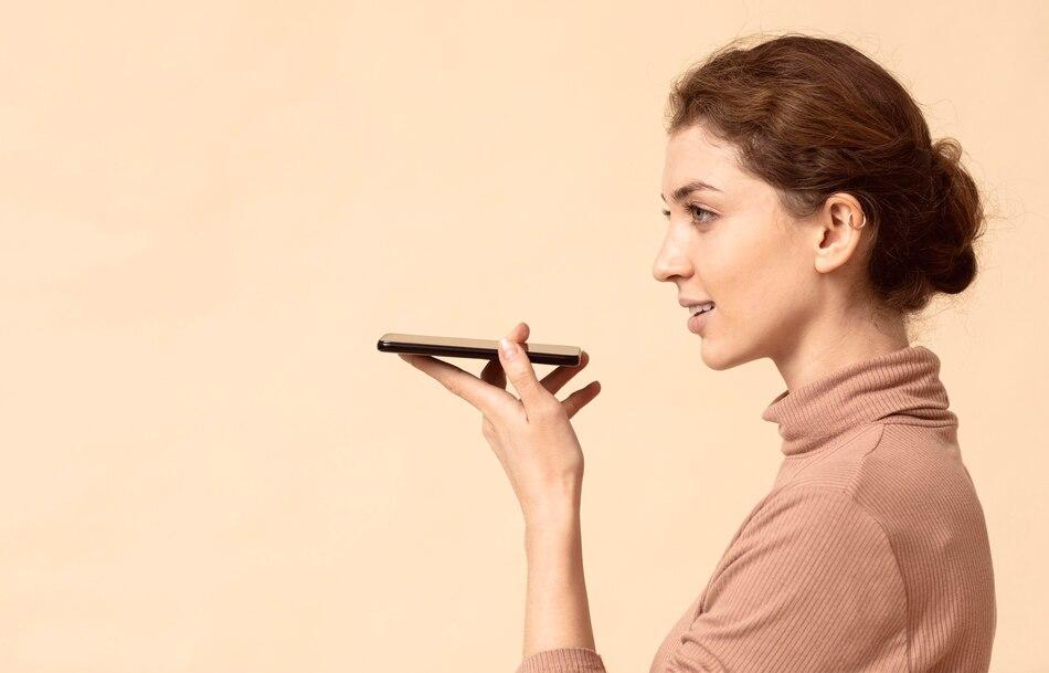 woman using voice recognition on her smartphone